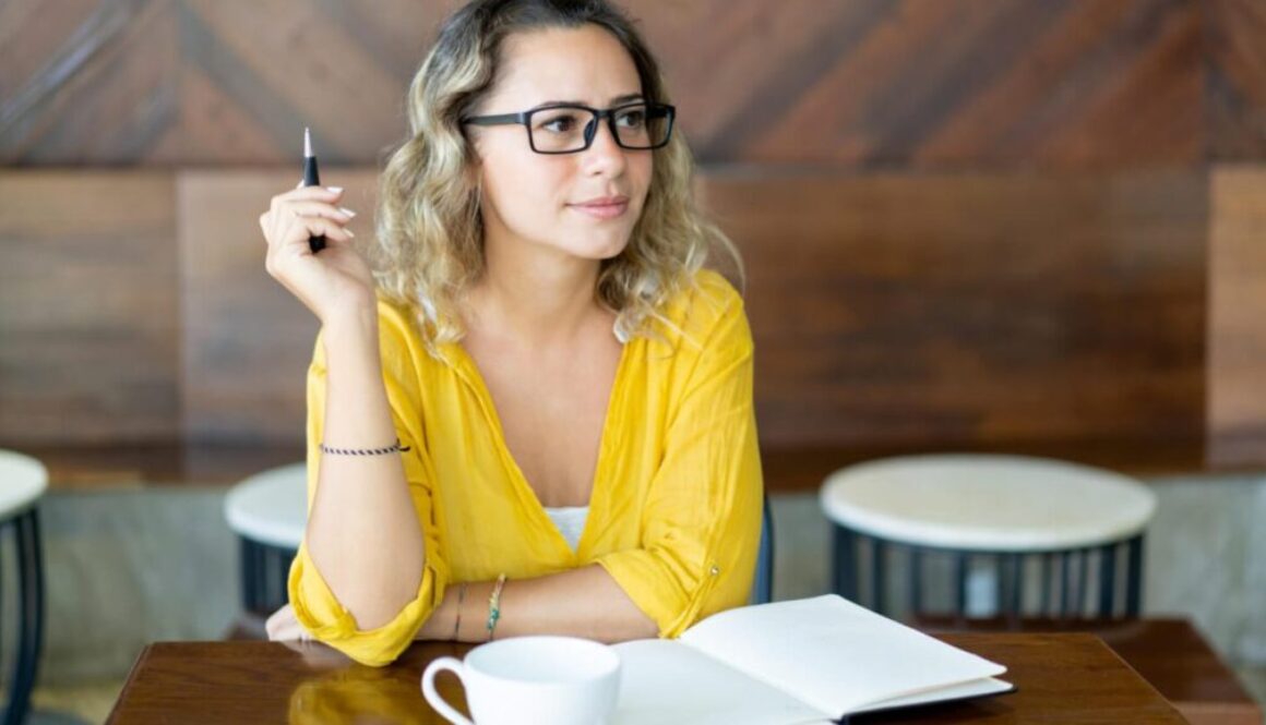 pretty-curly-young-woman-writing-notes-startup-project-1220x686